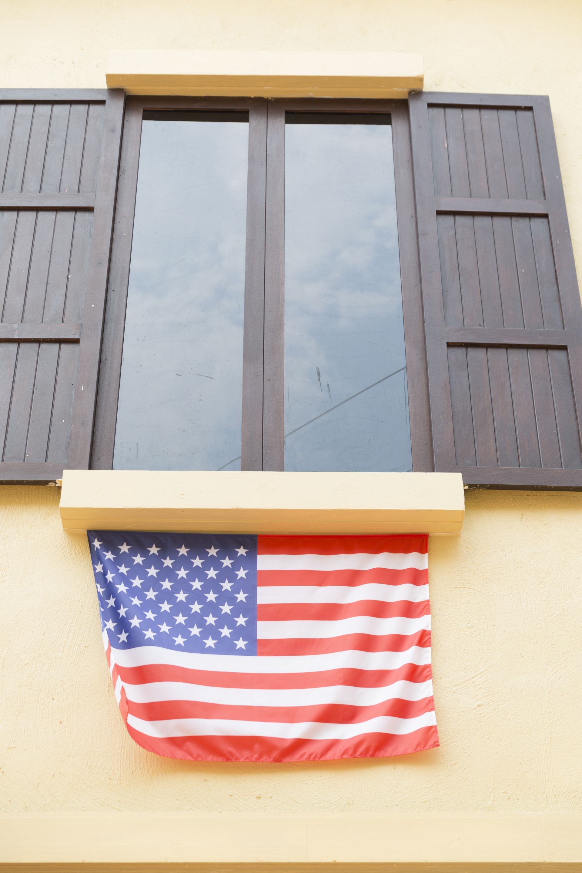 brown wooden window and tinted glass decorating with united states national flag