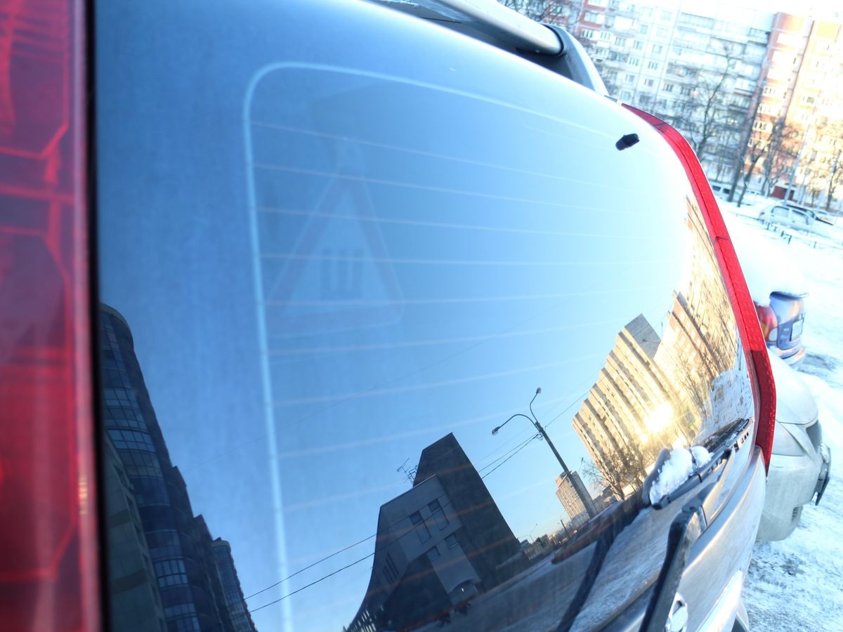 reflection in the rear window of the car