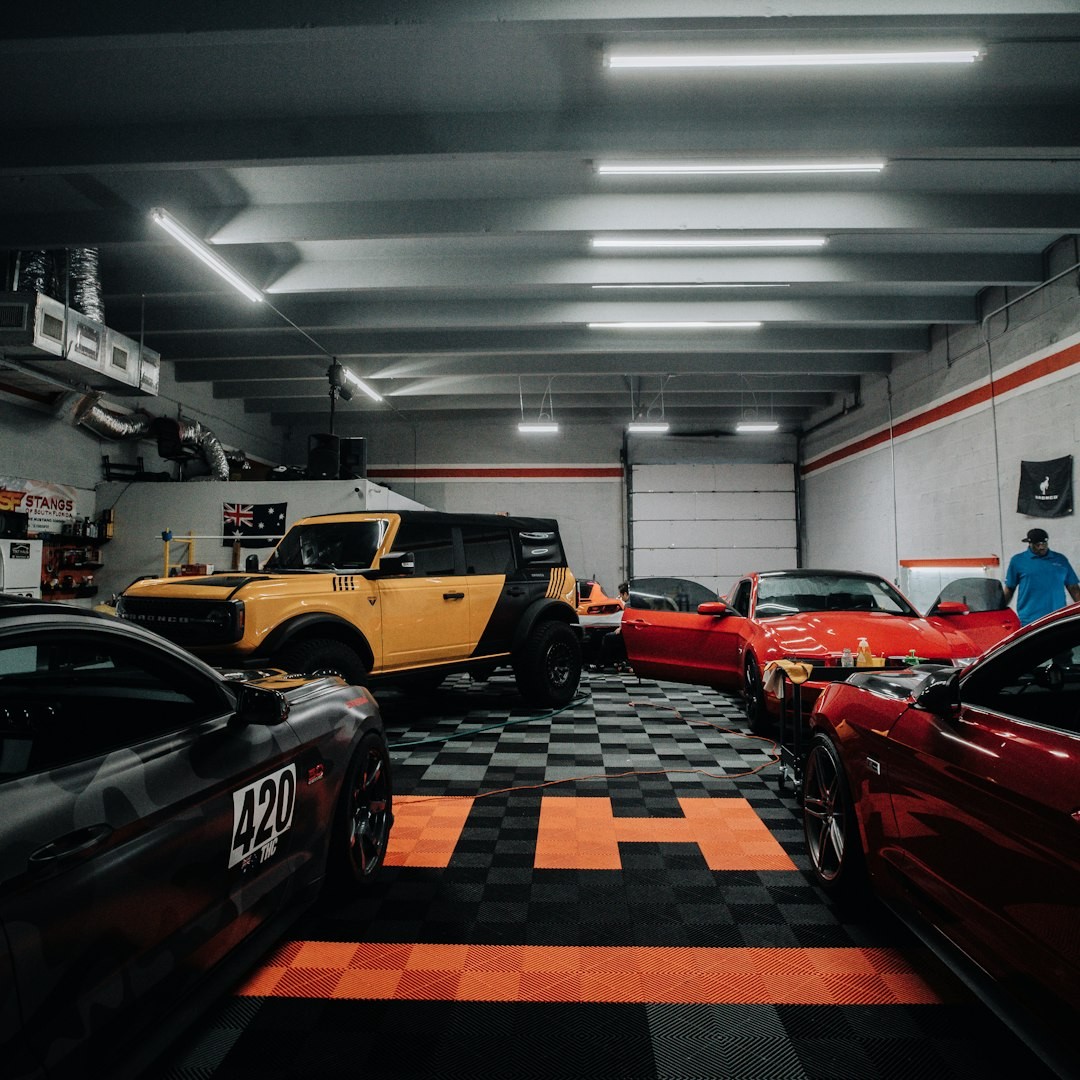 a garage filled with lots of different colored cars